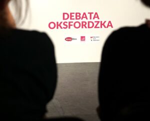 Debata oksfordzka - napis na planszy, pod nim logotypy